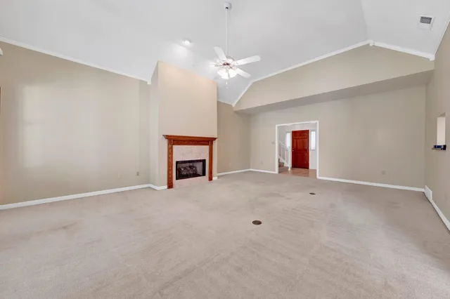a bathroom with a granite countertop sink a toilet a mirror and a bathtub