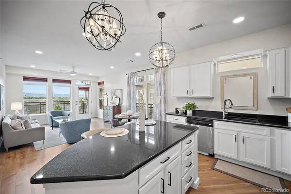 a large kitchen with lots of counter space and chandelier