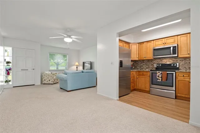 a kitchen with stainless steel appliances granite countertop a stove a sink and a refrigerator