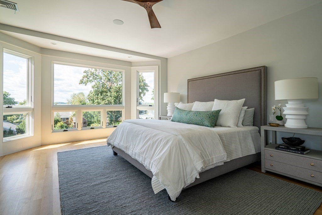 21 Jarvis Avenue Hingham, MA 02043 - Photo 17 of 30 a large bed sitting in a bedroom next to a window