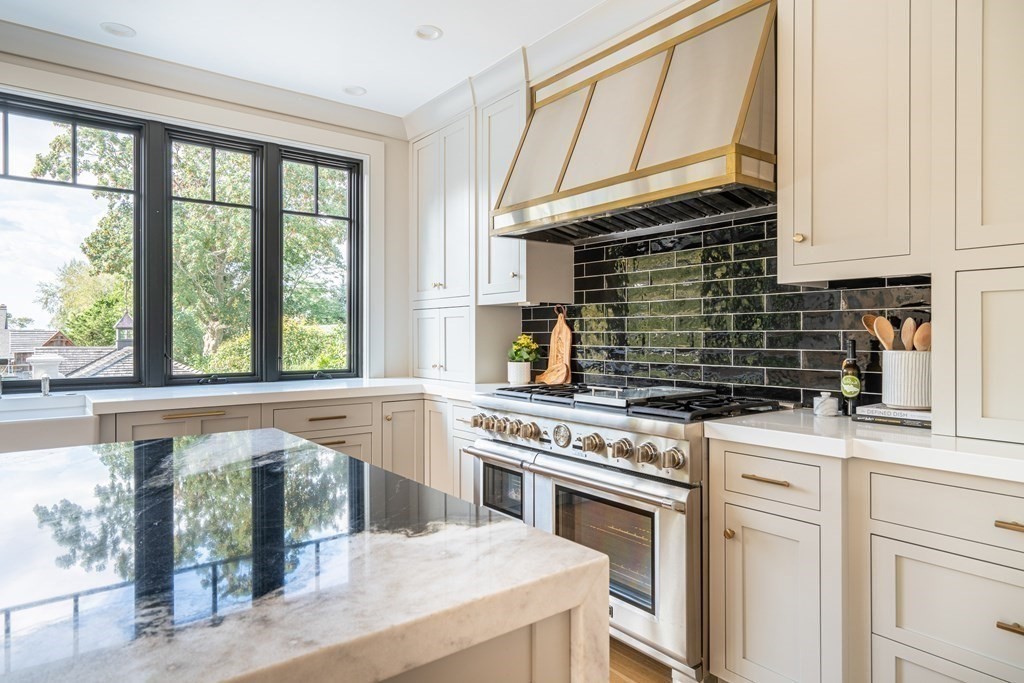 21 Jarvis Avenue Hingham, MA 02043 - Photo 7 of 30 a kitchen with a stove and a white cabinets