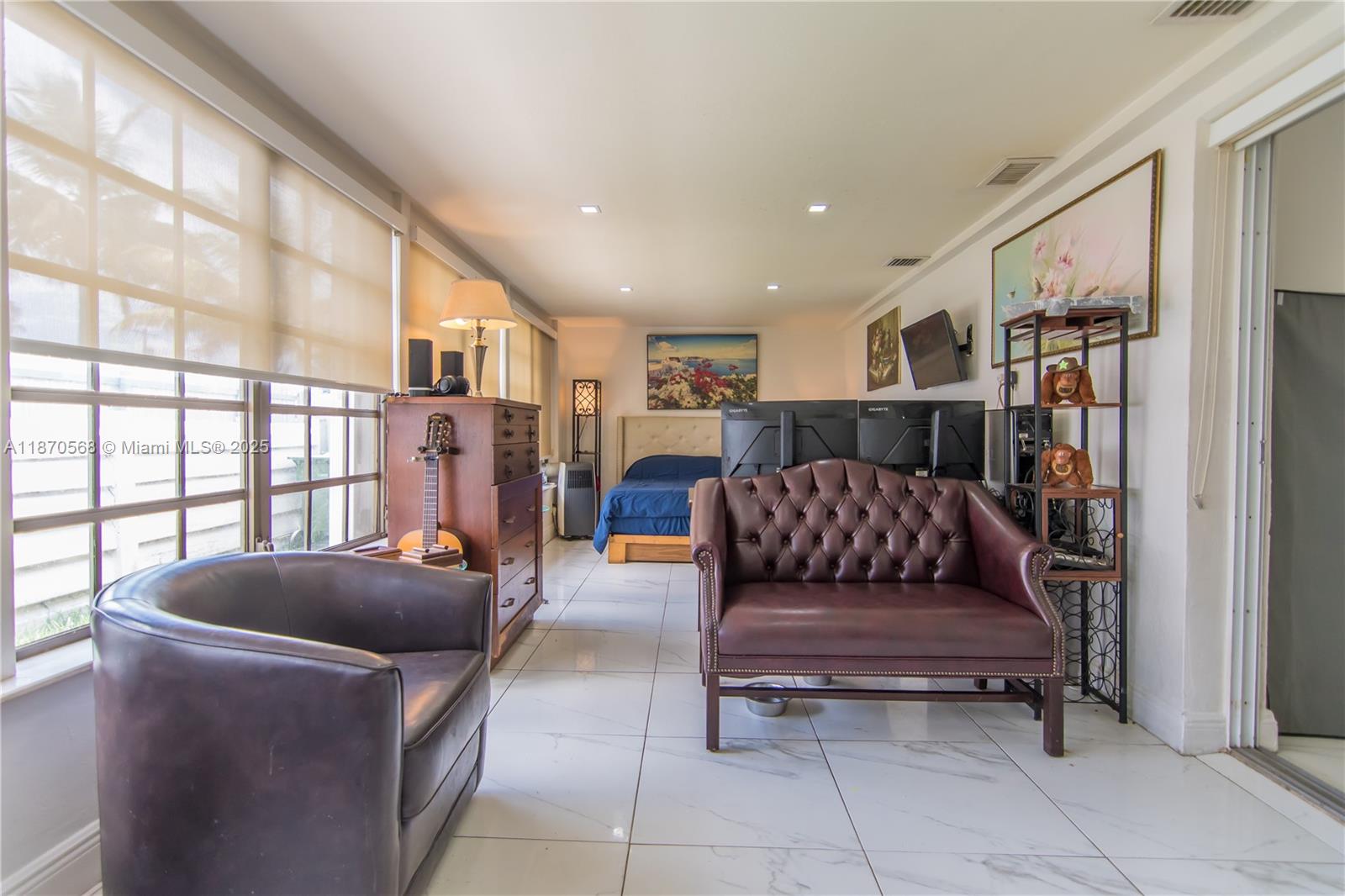 943 West 64th Place Hialeah, FL 33012 - Photo 12 of 32 a living room with furniture and a window