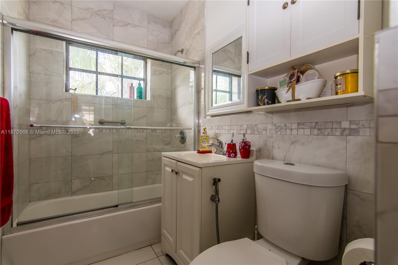 943 West 64th Place Hialeah, FL 33012 - Photo 16 of 32 a bathroom with a sink toilet and shower