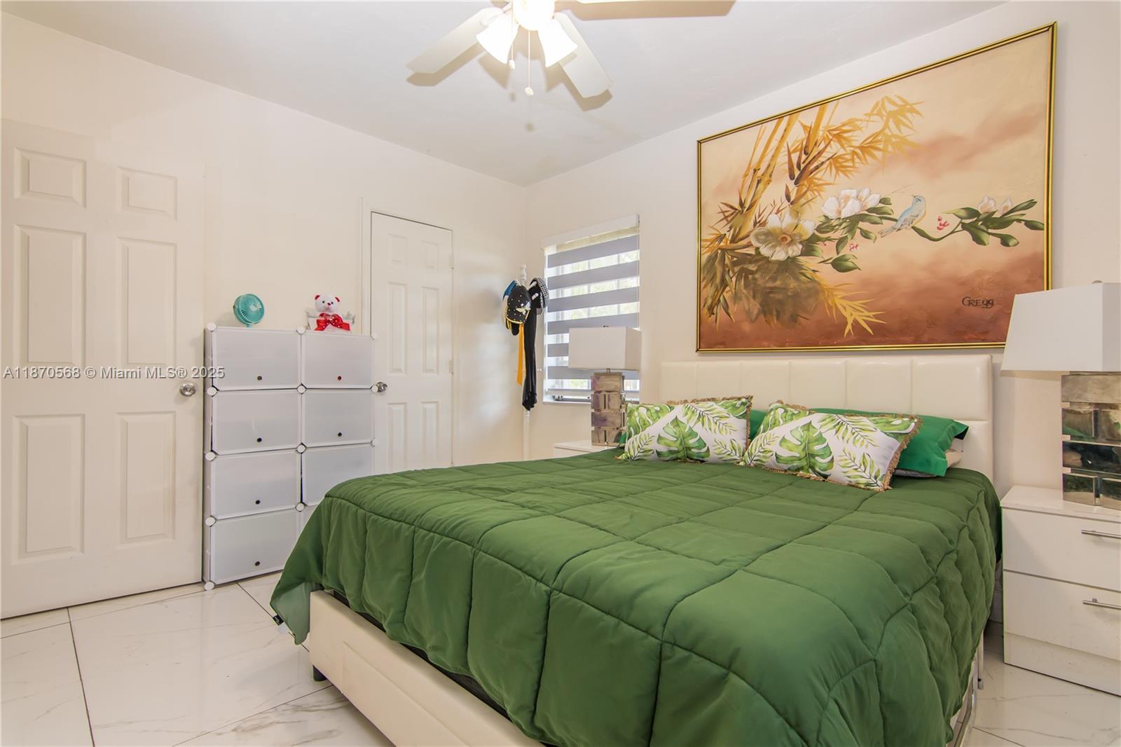 943 West 64th Place Hialeah, FL 33012 - Photo 19 of 32 a bedroom with a bed and a window