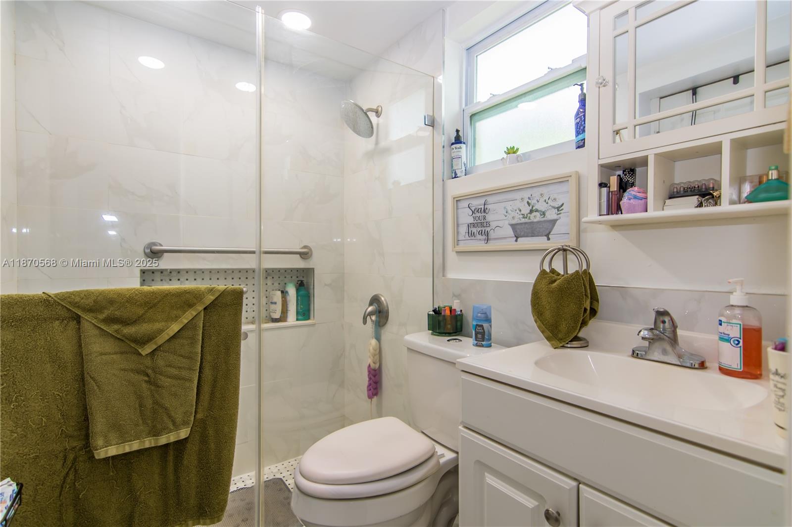 943 West 64th Place Hialeah, FL 33012 - Photo 22 of 32 a bathroom with a toilet sink and mirror