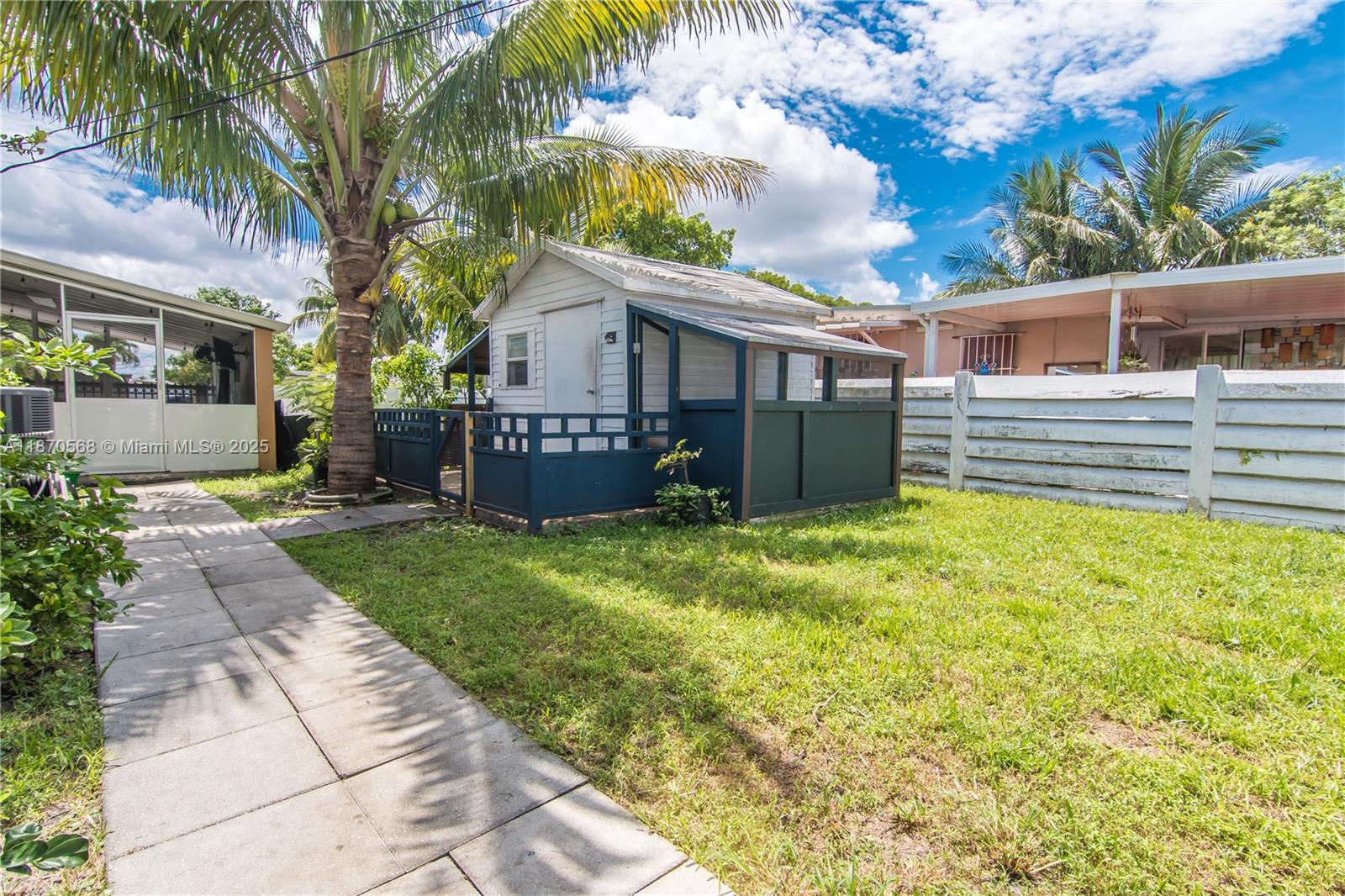 943 West 64th Place Hialeah, FL 33012 - Photo 23 of 32 a view of a house with a backyard