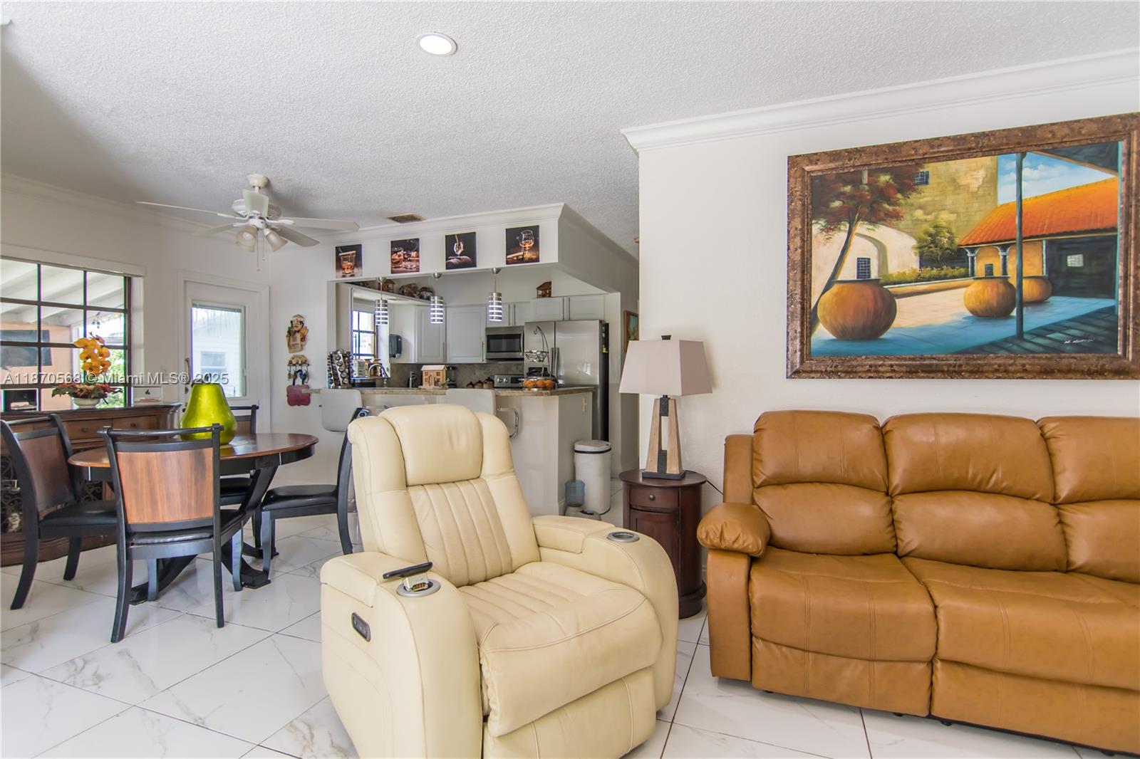 943 West 64th Place Hialeah, FL 33012 - Photo 5 of 32 a living room with furniture and painting on the wall