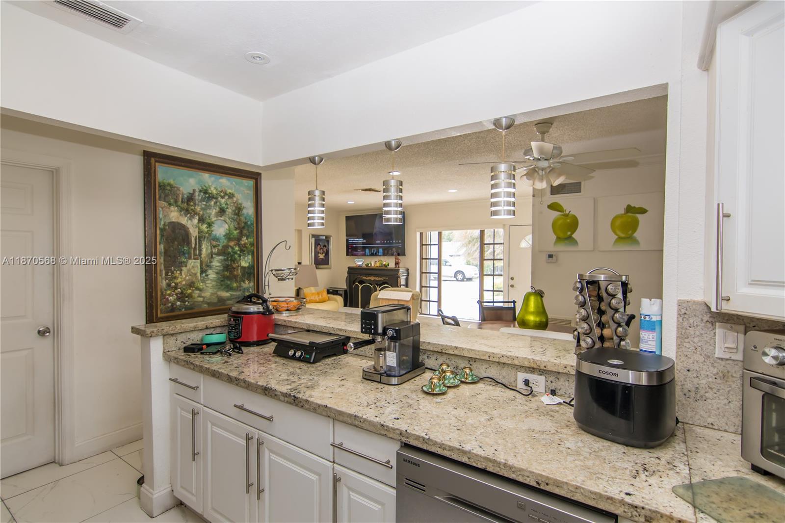 943 West 64th Place Hialeah, FL 33012 - Photo 8 of 32 a kitchen with sink and potted plant