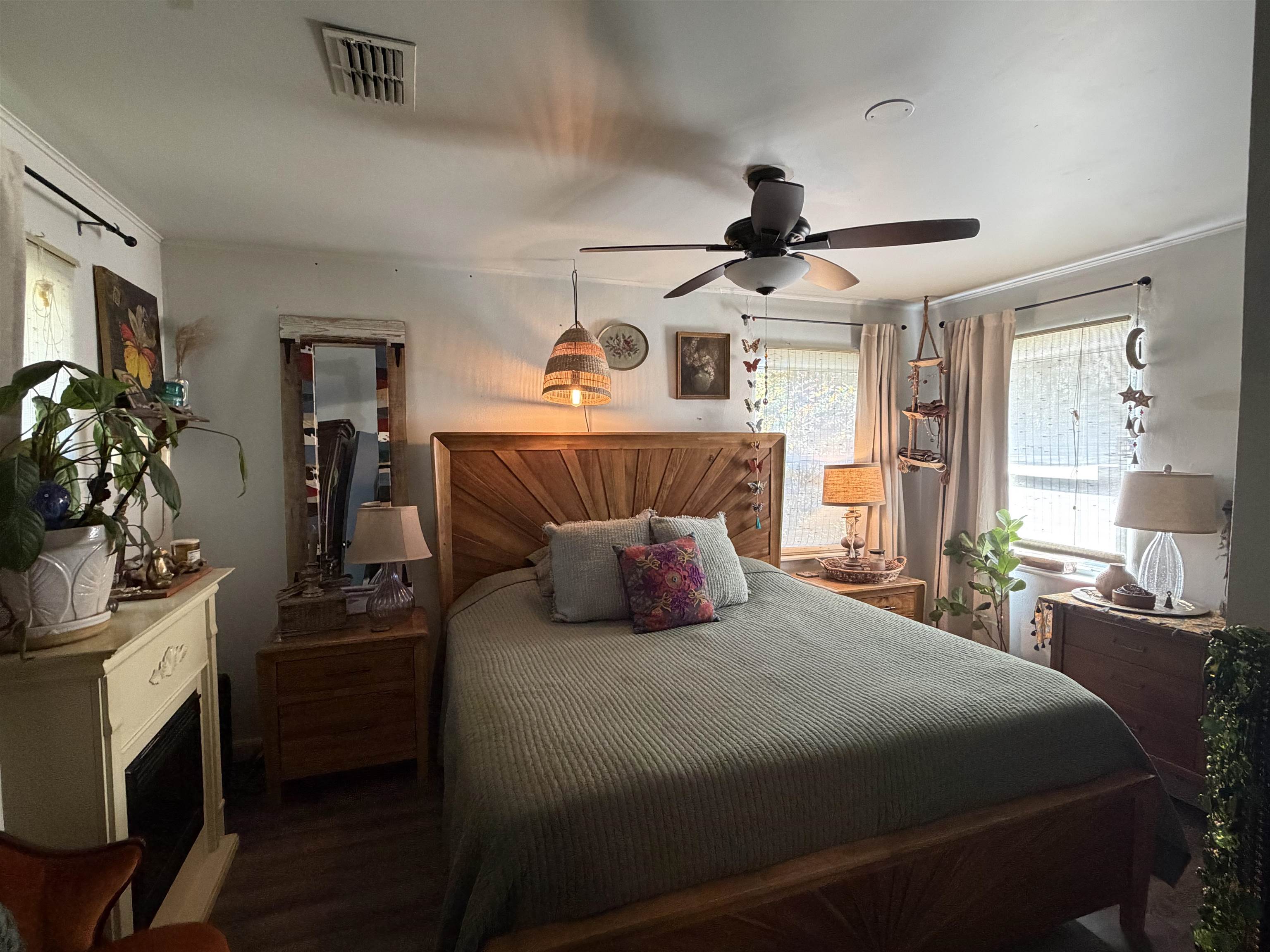 323 Sisco Road Pomona Park, FL 32181 - Photo 28 of 31 a bedroom with a bed a chandelier and flat screen tv