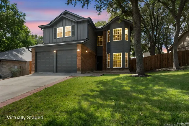 a front view of a house with a yard and garage