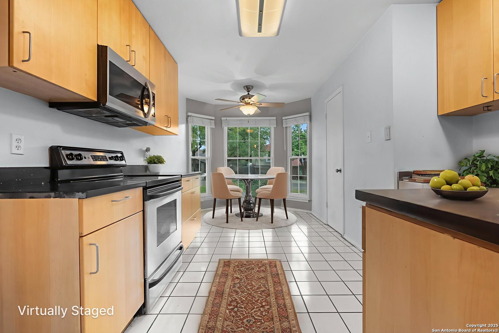 3813 Ogelthorpe Circle Schertz, TX 78154 - Photo 8 of 32 a kitchen with stainless steel appliances granite countertop a stove a sink a microwave and a dining table