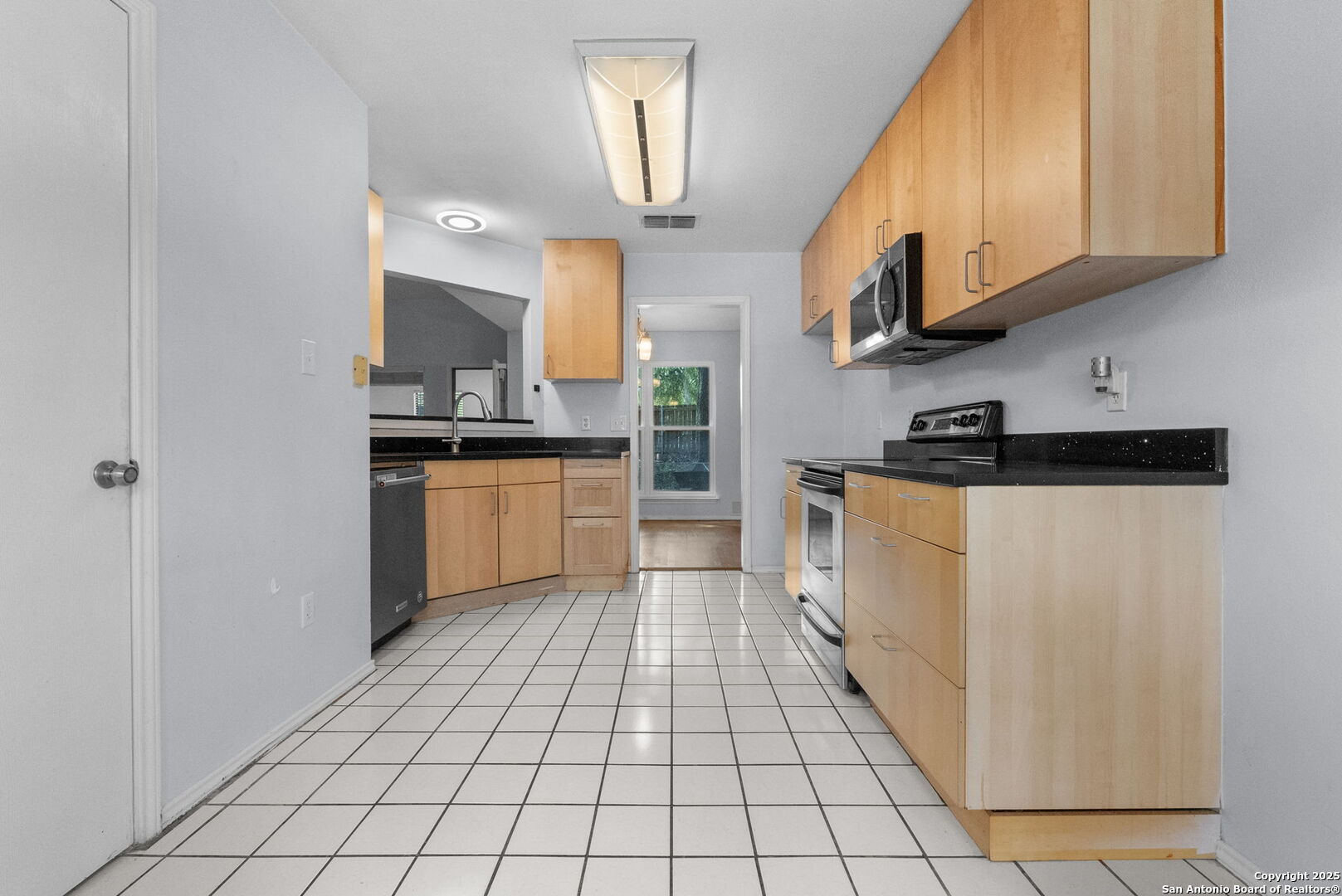 3813 Ogelthorpe Circle Schertz, TX 78154 - Photo 10 of 32 a kitchen with stainless steel appliances granite countertop a stove a sink and a refrigerator