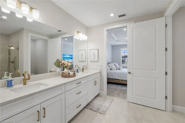 a en suite bathroom with double sink and a mirror
