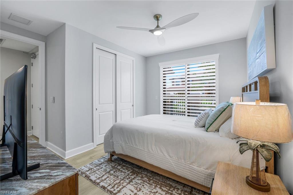 15336 Lucerna Street, Unit 104 Naples, FL 34114 - Photo 13 of 17 a bedroom with a bed and a window