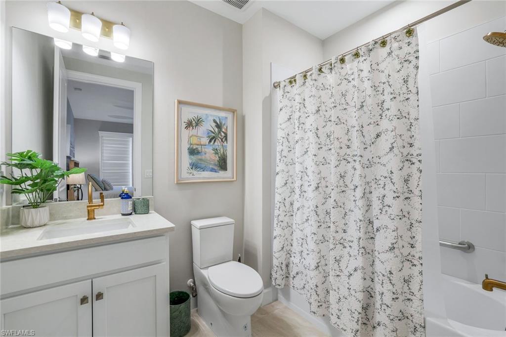 15336 Lucerna Street, Unit 104 Naples, FL 34114 - Photo 14 of 17 a bathroom with a sink toilet and shower