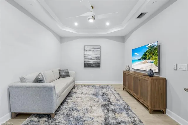 a living room with furniture and painting on the wall