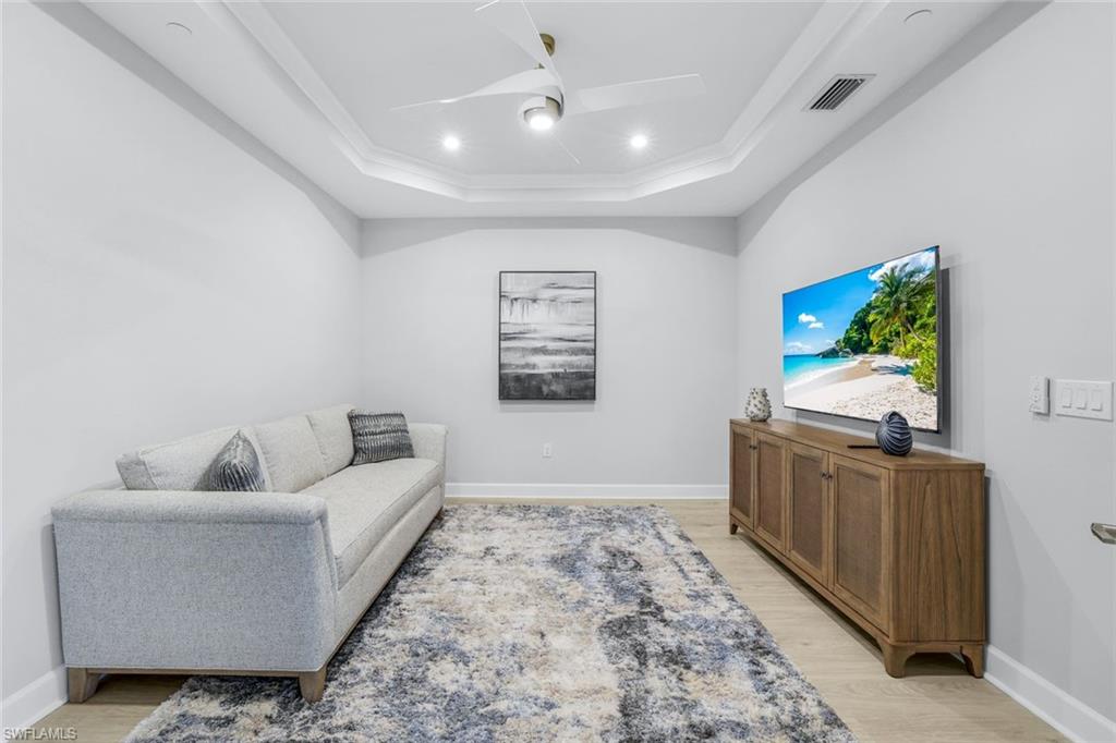 15336 Lucerna Street, Unit 104 Naples, FL 34114 - Photo 15 of 17 a living room with furniture and painting on the wall
