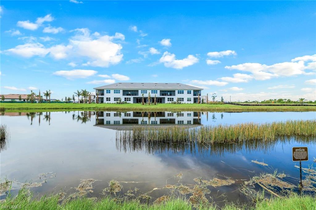 15336 Lucerna Street, Unit 104 Naples, FL 34114 - Photo 17 of 17 a view of a lake with a big yard