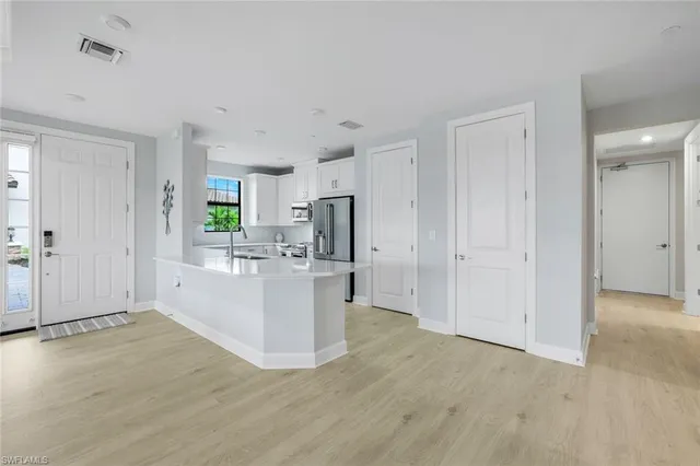 a view of kitchen with refrigerator stove microwave and cabinets
