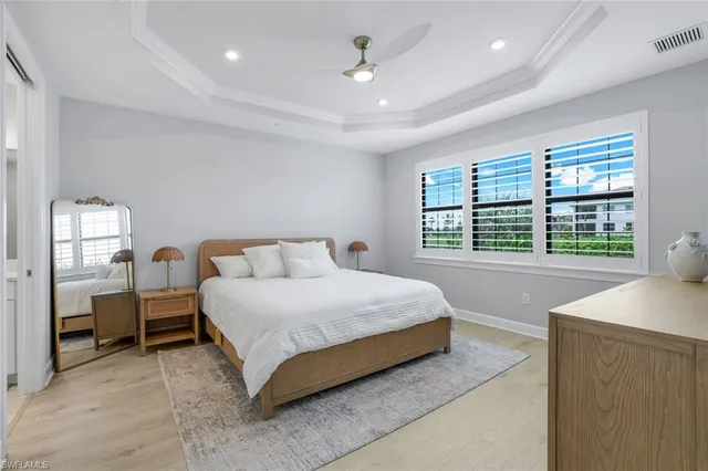 a spacious bedroom with a bed and a table in it