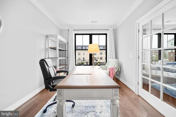 a living room with furniture and floor to ceiling windows