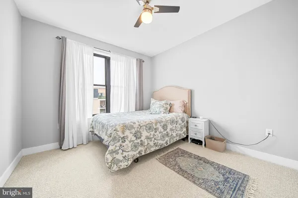 a view of staircase with lots of frames on wall and wooden floor