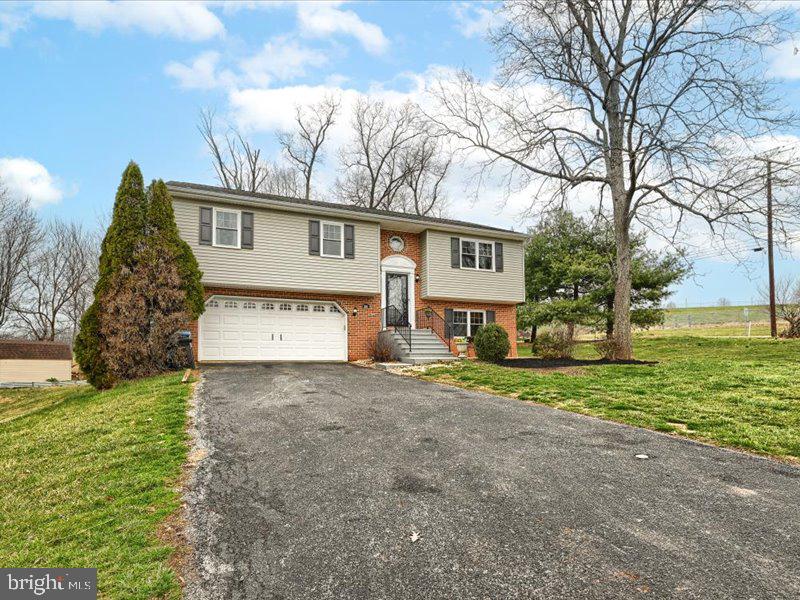301 Larkin Drive Red Lion, PA 17356 - Photo 3 of 61 a view of a house with a yard and garage