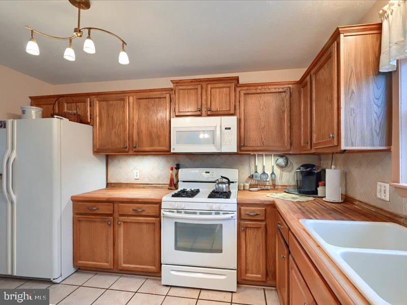 301 Larkin Drive Red Lion, PA 17356 - Photo 35 of 61 a kitchen with stainless steel appliances granite countertop a sink stove and refrigerator
