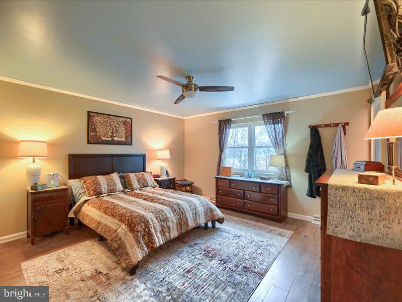 301 Larkin Drive Red Lion, PA 17356 - Photo 38 of 61 a bedroom with a large bed and a chandelier