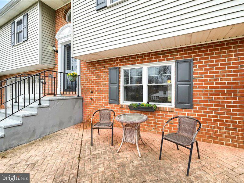 301 Larkin Drive Red Lion, PA 17356 - Photo 8 of 61 a patio with a table and chairs and potted plants