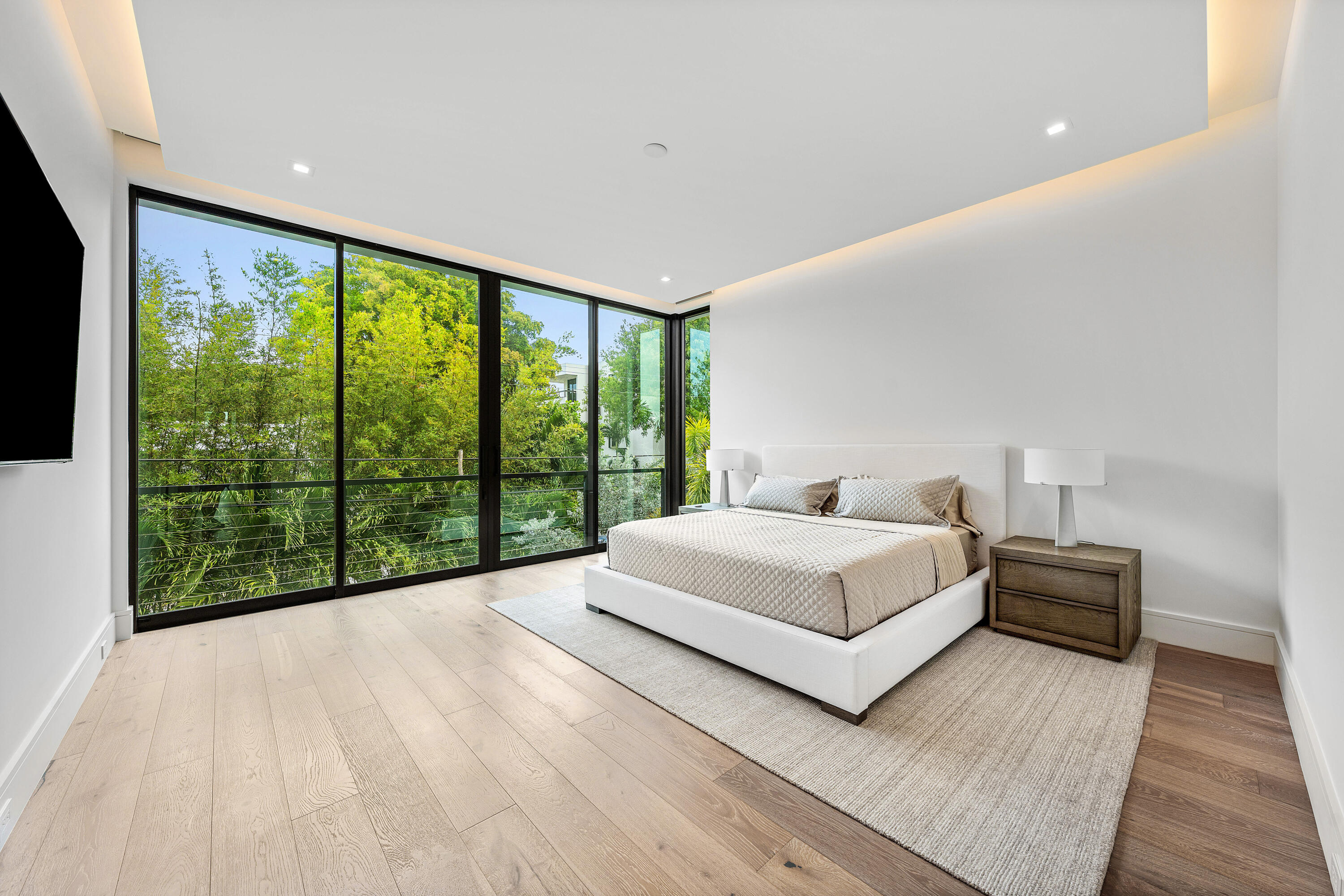 320 Northeast Wavecrest Way Boca Raton, FL 33432 - Photo 38 of 65 a bedroom with a large bed and a large window