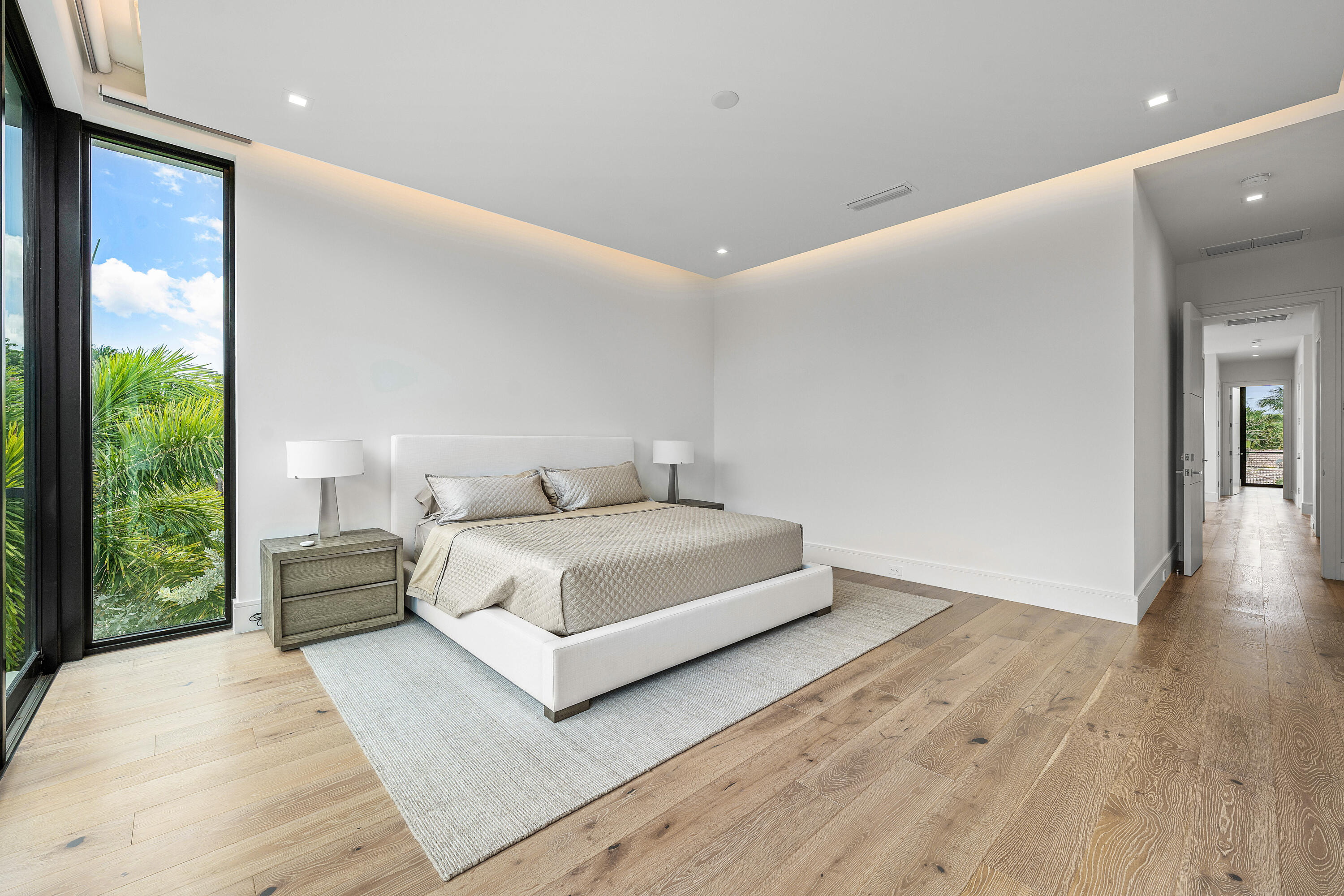 320 Northeast Wavecrest Way Boca Raton, FL 33432 - Photo 39 of 65 a spacious bedroom with a bed and a large window
