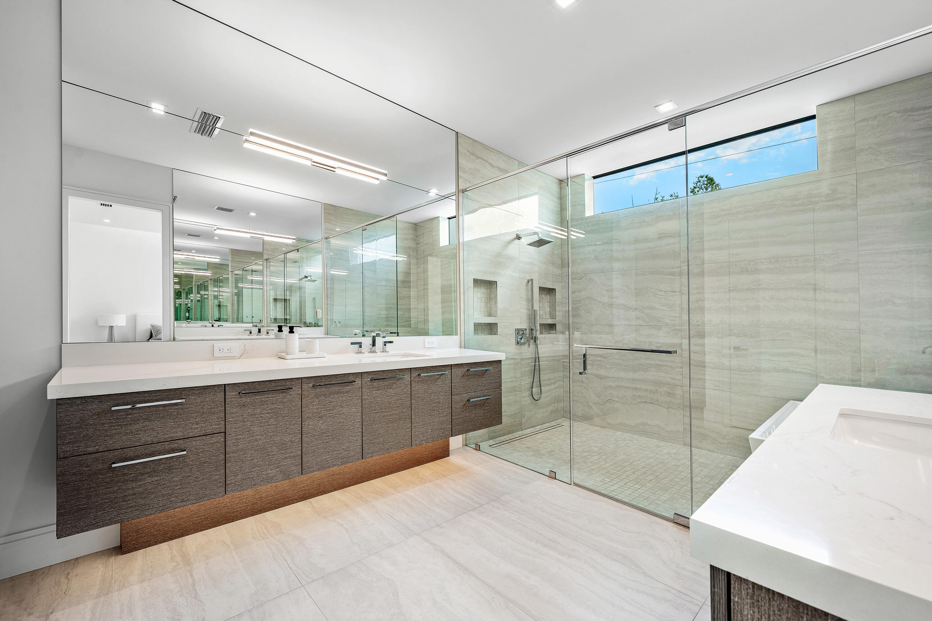320 Northeast Wavecrest Way Boca Raton, FL 33432 - Photo 44 of 65 a bathroom with a sink mirror and a shower