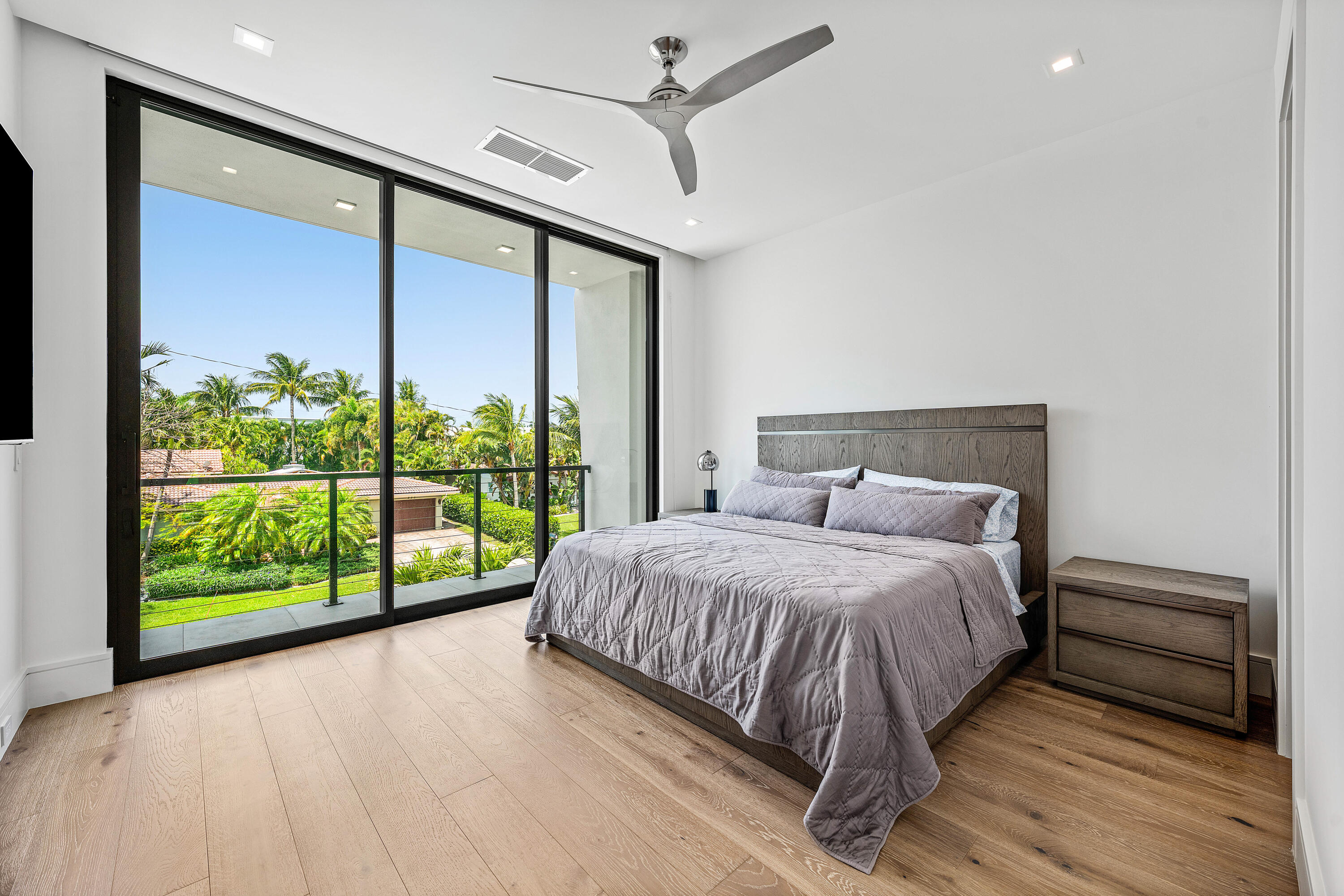 320 Northeast Wavecrest Way Boca Raton, FL 33432 - Photo 49 of 65 a bedroom with a large bed and a large window