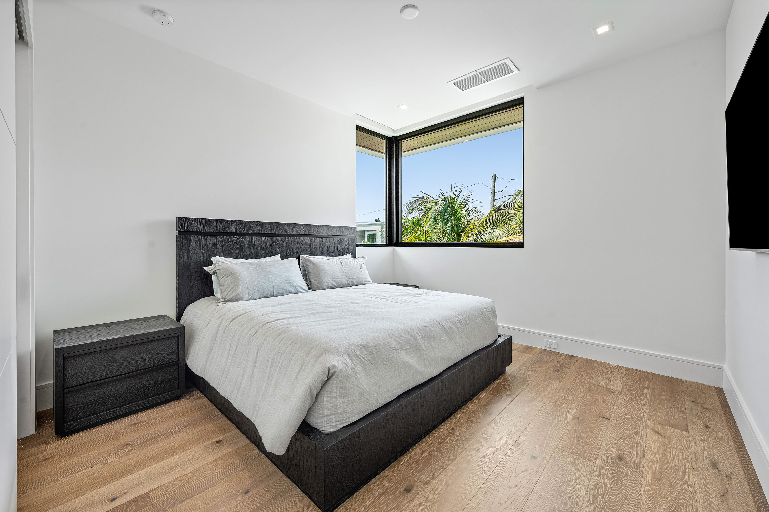 320 Northeast Wavecrest Way Boca Raton, FL 33432 - Photo 51 of 65 a large bed sitting in a bedroom next to a window