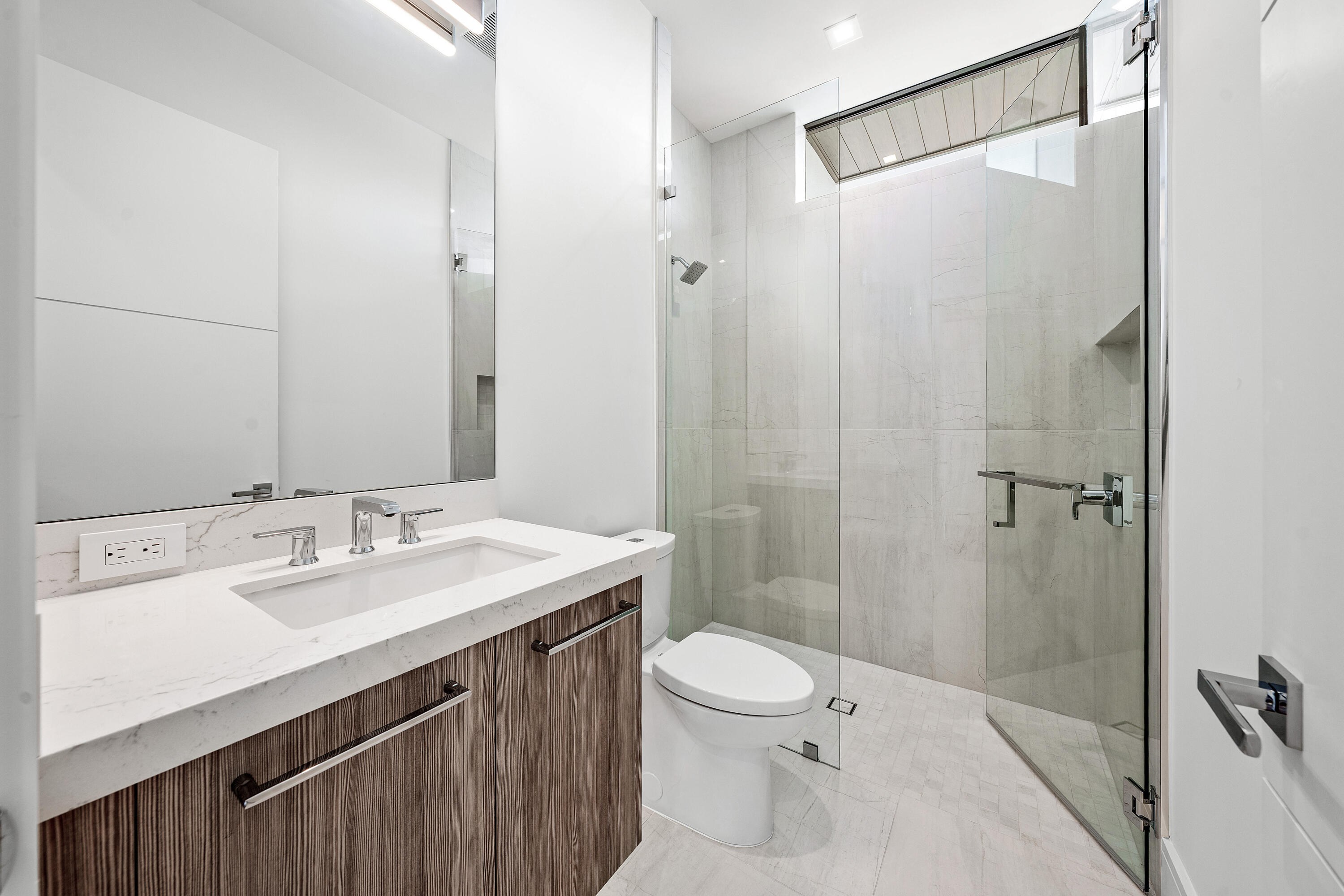 320 Northeast Wavecrest Way Boca Raton, FL 33432 - Photo 52 of 65 a bathroom with a sink a toilet and shower