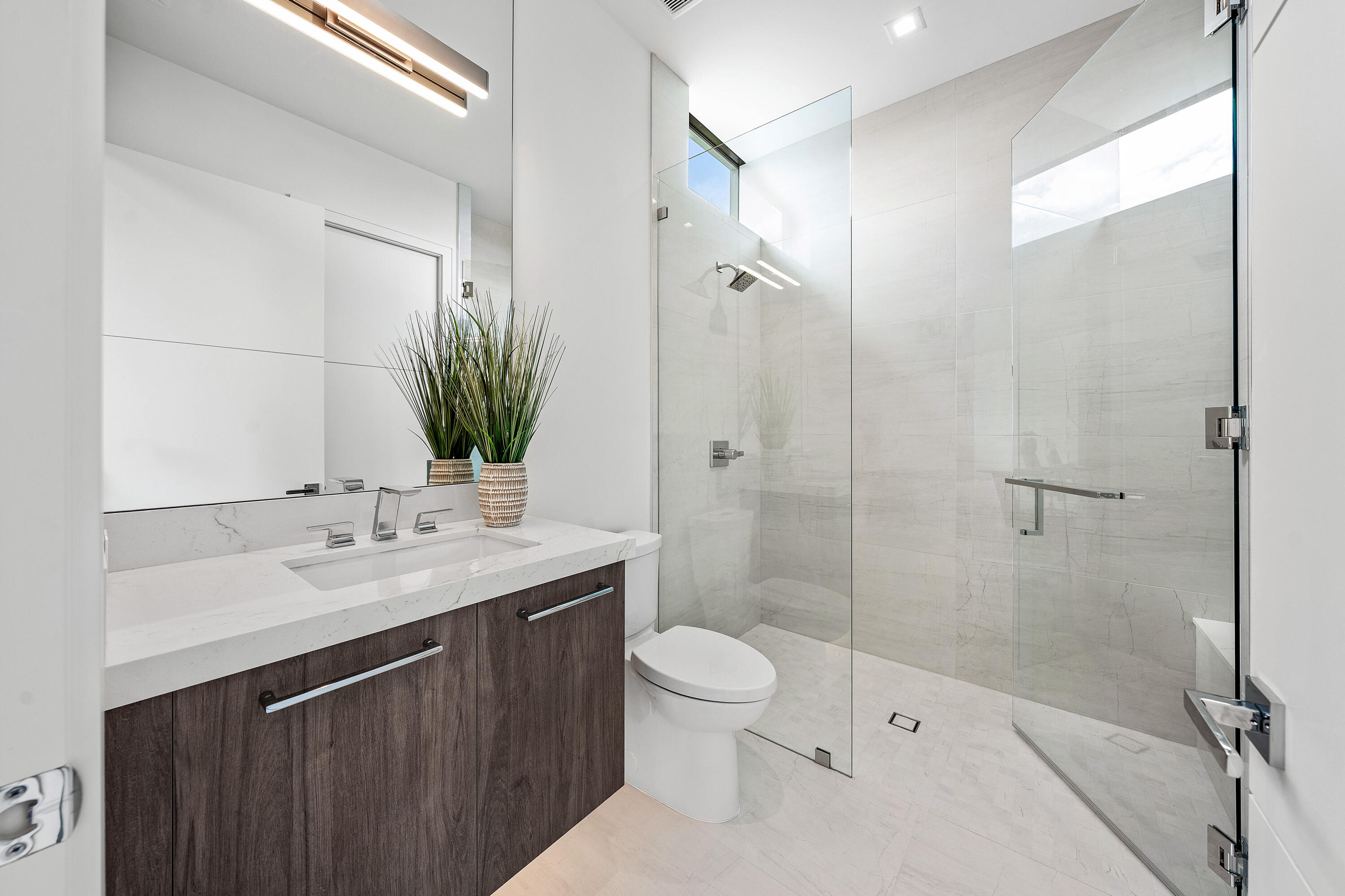 320 Northeast Wavecrest Way Boca Raton, FL 33432 - Photo 54 of 65 a bathroom with a sink a toilet and shower