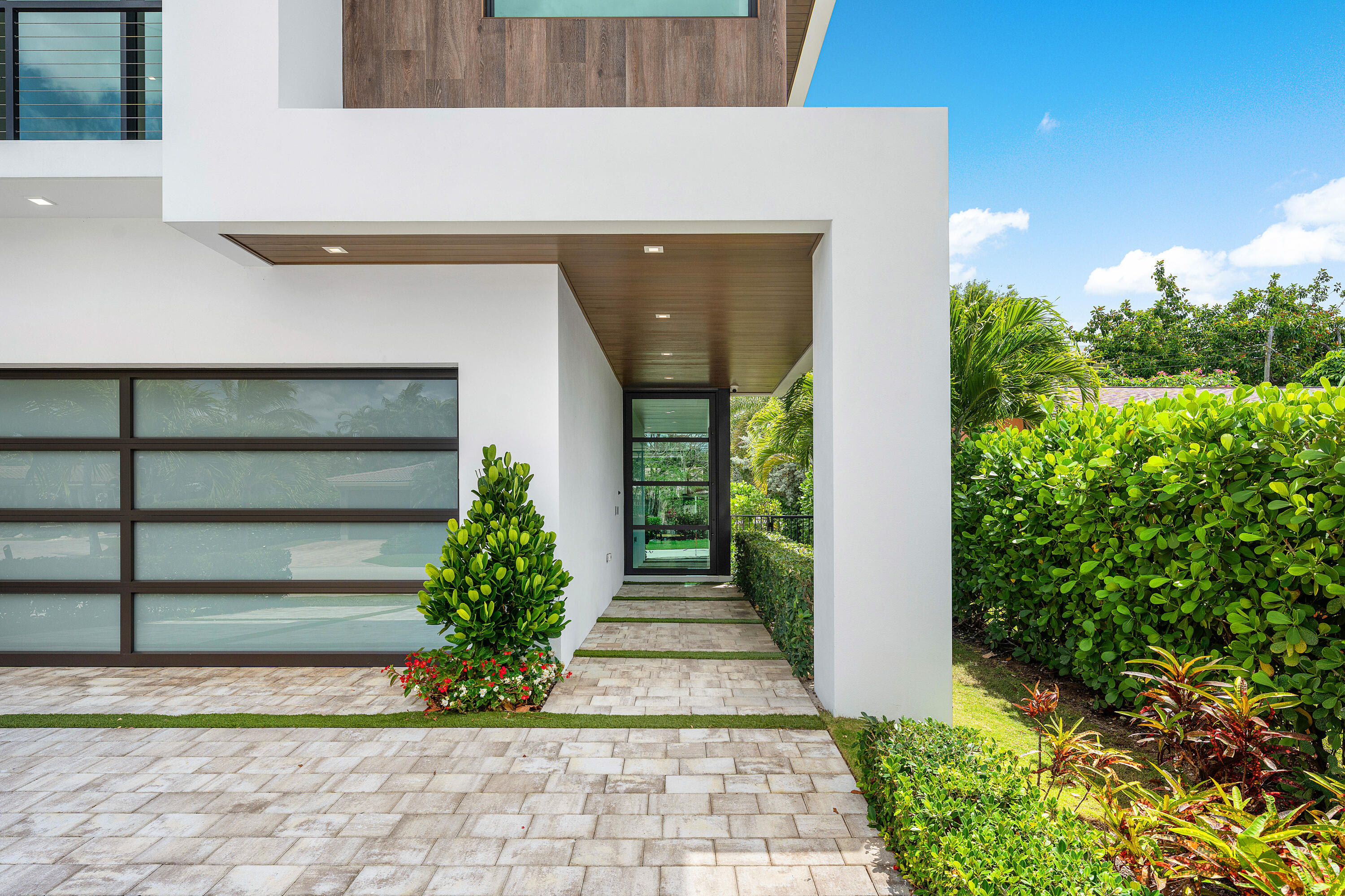 320 Northeast Wavecrest Way Boca Raton, FL 33432 - Photo 6 of 65 a front view of a house with a yard