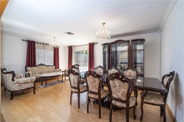 a view of a dining room with furniture and chandelier