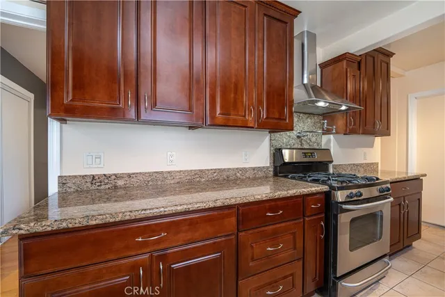 a kitchen with granite countertop a stove and a sink