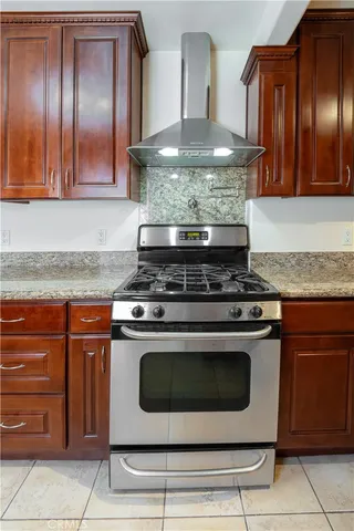 a stove top oven sitting inside of a kitchen