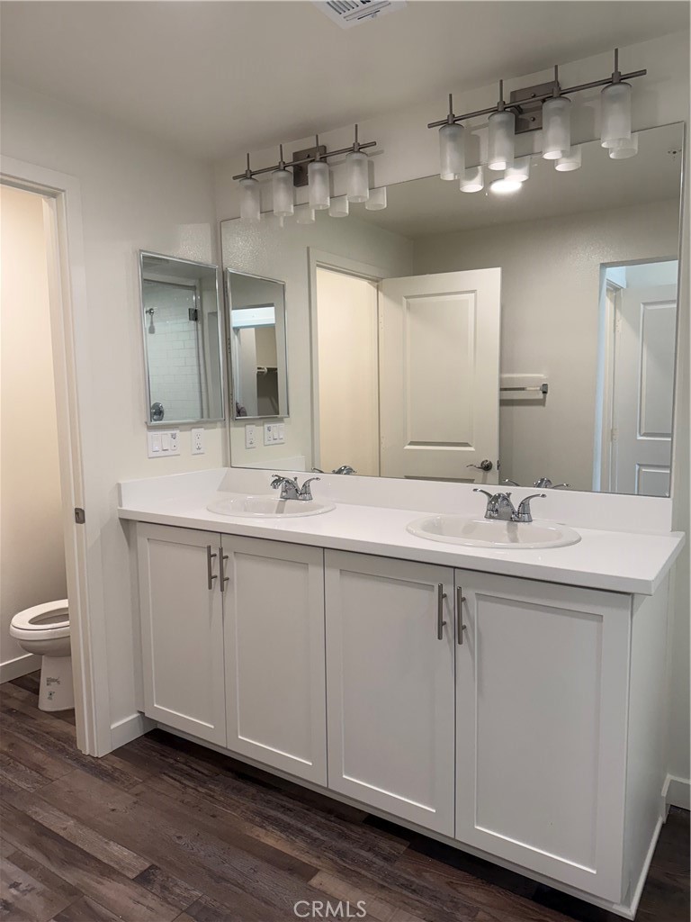 78 Bigsby Drive Stanton, CA 90680 - Photo 2 of 9 a bathroom with a double vanity sink and a mirror