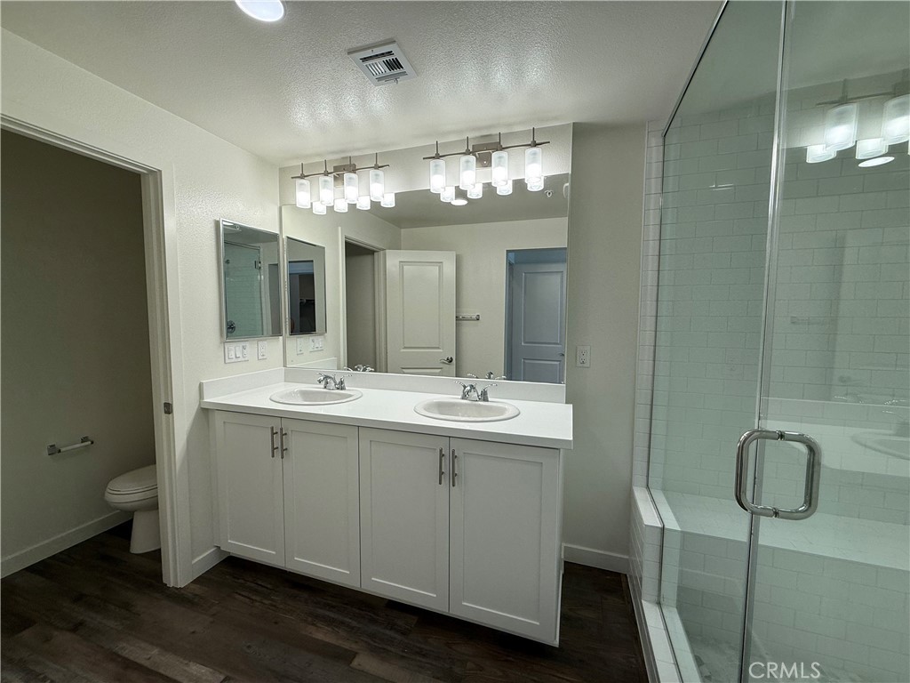 78 Bigsby Drive Stanton, CA 90680 - Photo 6 of 9 a bathroom with a double vanity sink and a mirror