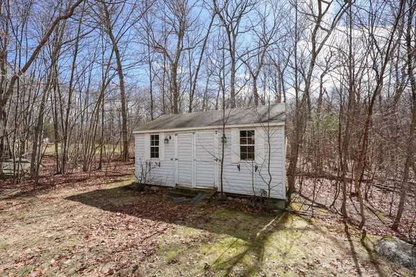 a view of a house with a yard covered in snow