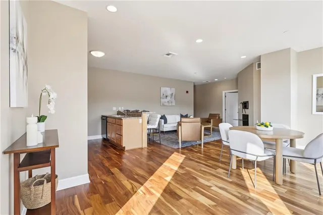 a kitchen with granite countertop a stove and a wooden floors