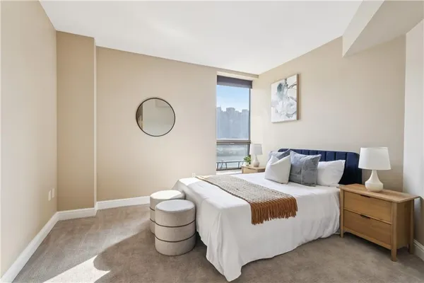 a bedroom with a large bed and a large window