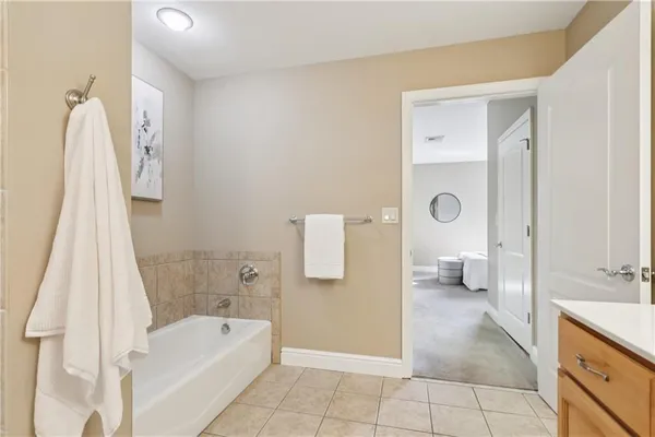a spacious bathroom with a double vanity sink a mirror and a