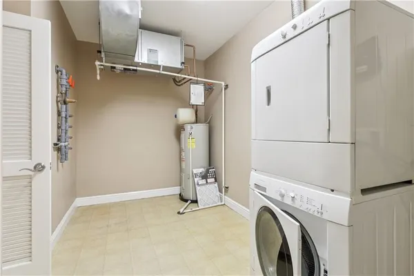 a white toilet sitting next to a white wall