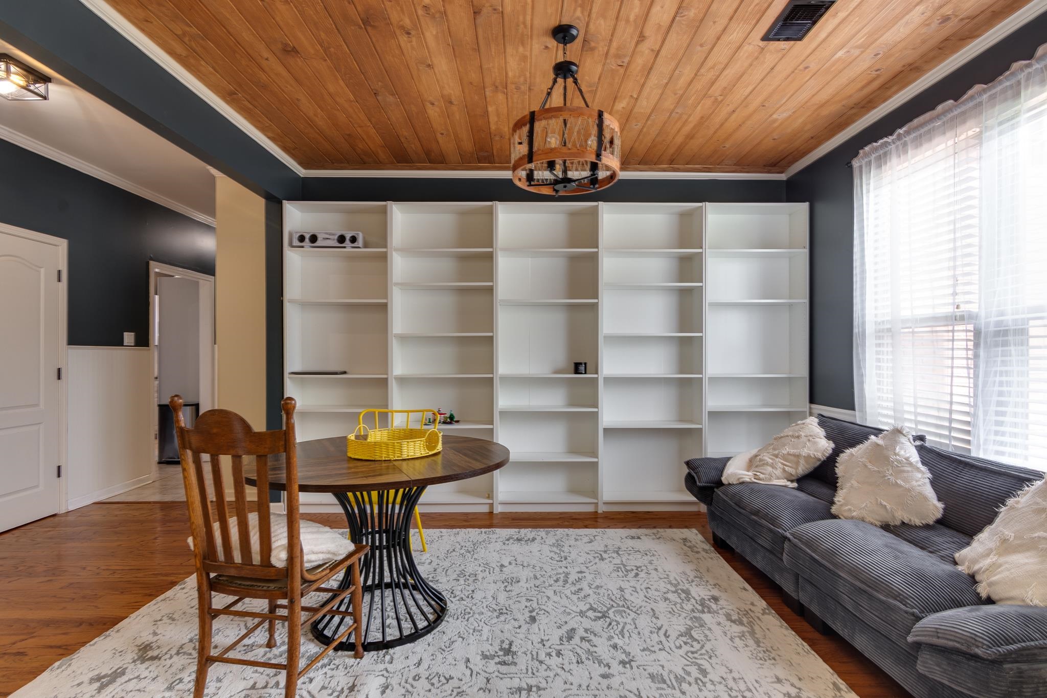 779 Early Earner Cove Collierville, TN 38017 - Photo 3 of 29 Room featuring a wood-panel ceiling, dark accent wall, and built-in shelving