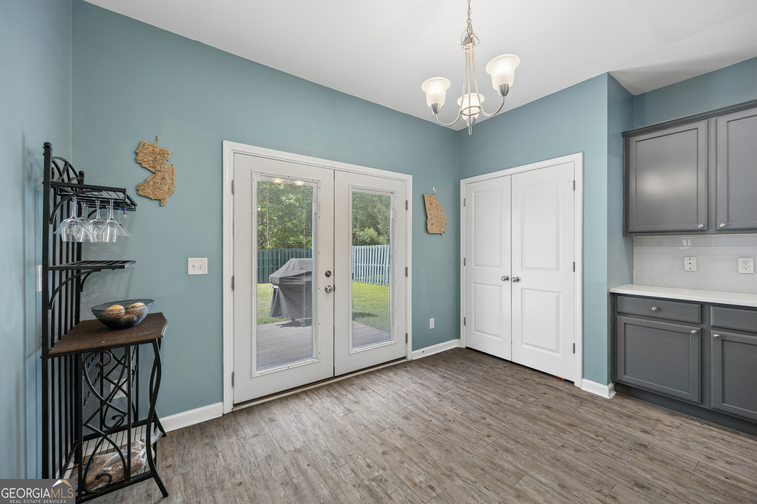 369 Waybridge Way Richmond Hill, GA 31324 - Photo 21 of 40 a view of a hallway with wooden floor and a chandelier